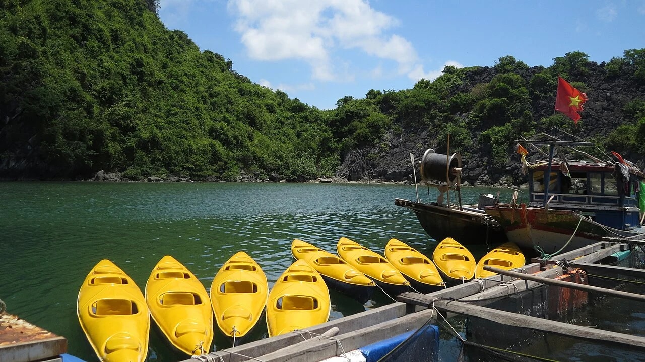 Yellow kayaks moored beside a boat in Cat Ba in 2017