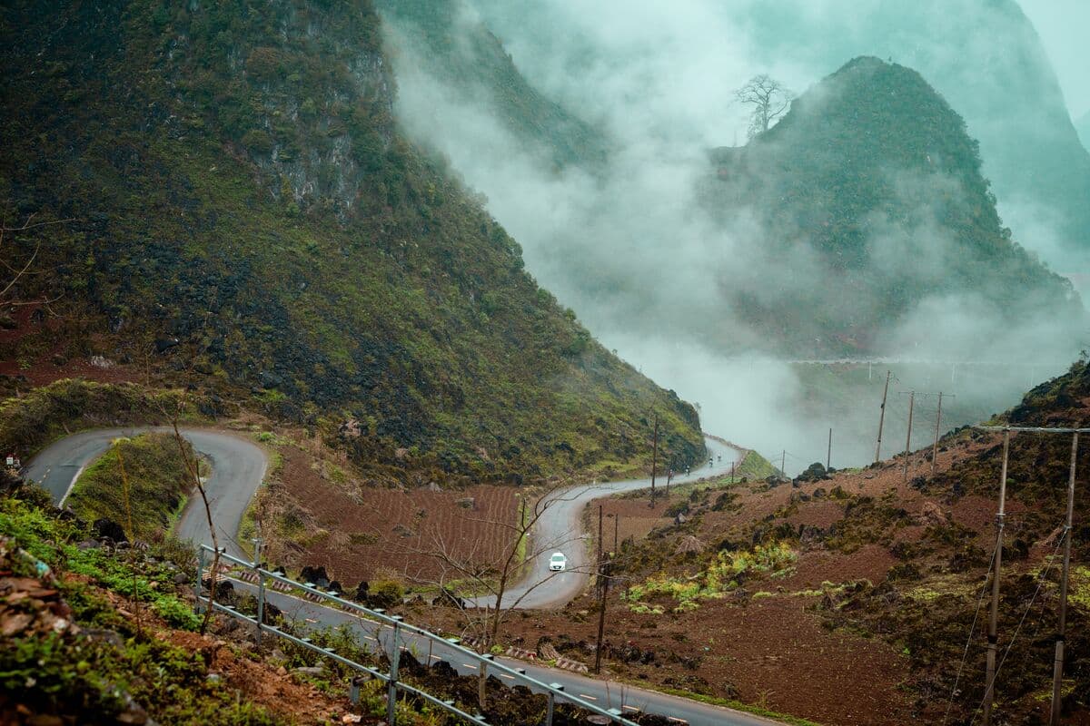 Mountain pass in Ha Giang with mist rolling over the karst peaks