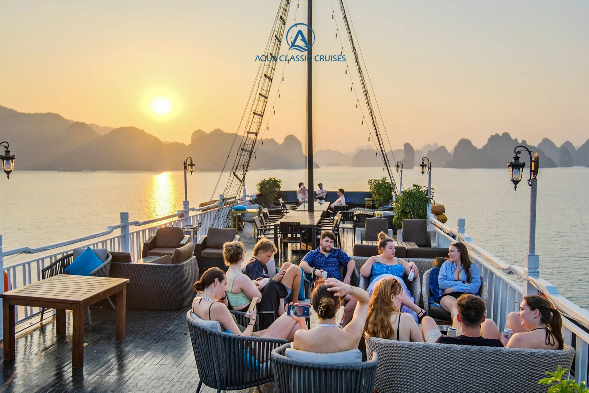 Guests on the Aqua Classic sundeck at sunset