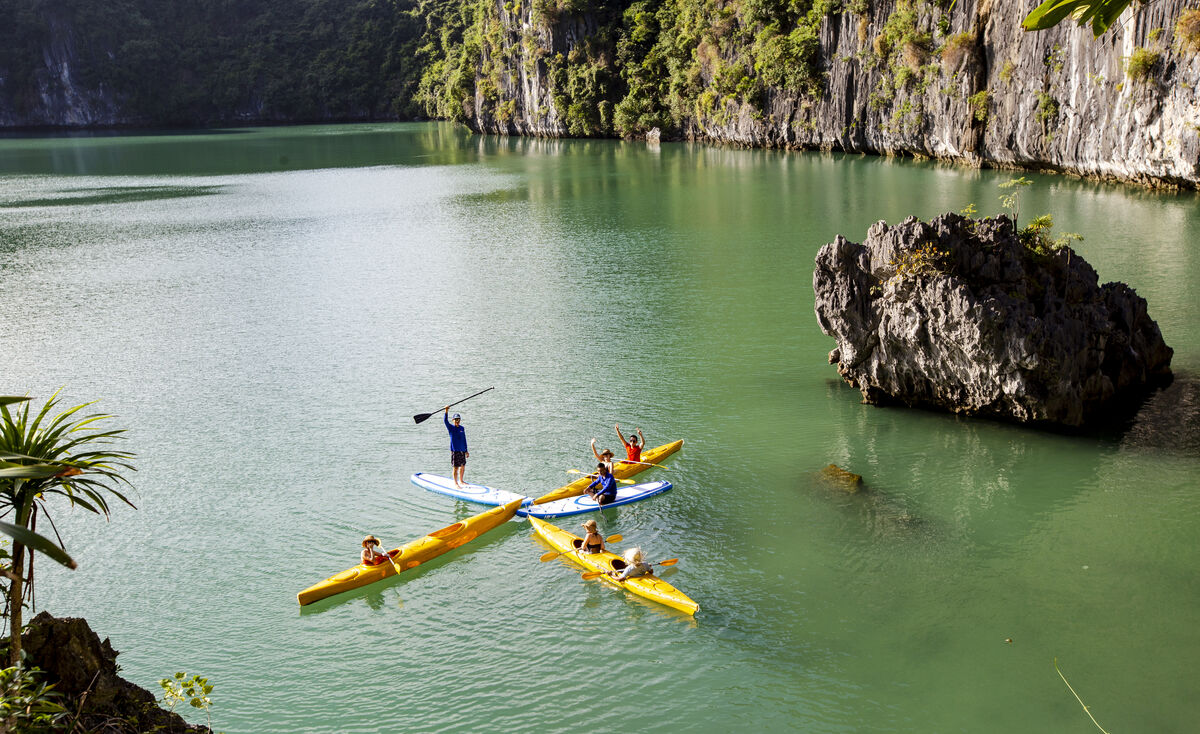 Kayaks lined up on the water in Lan Ha Bay
