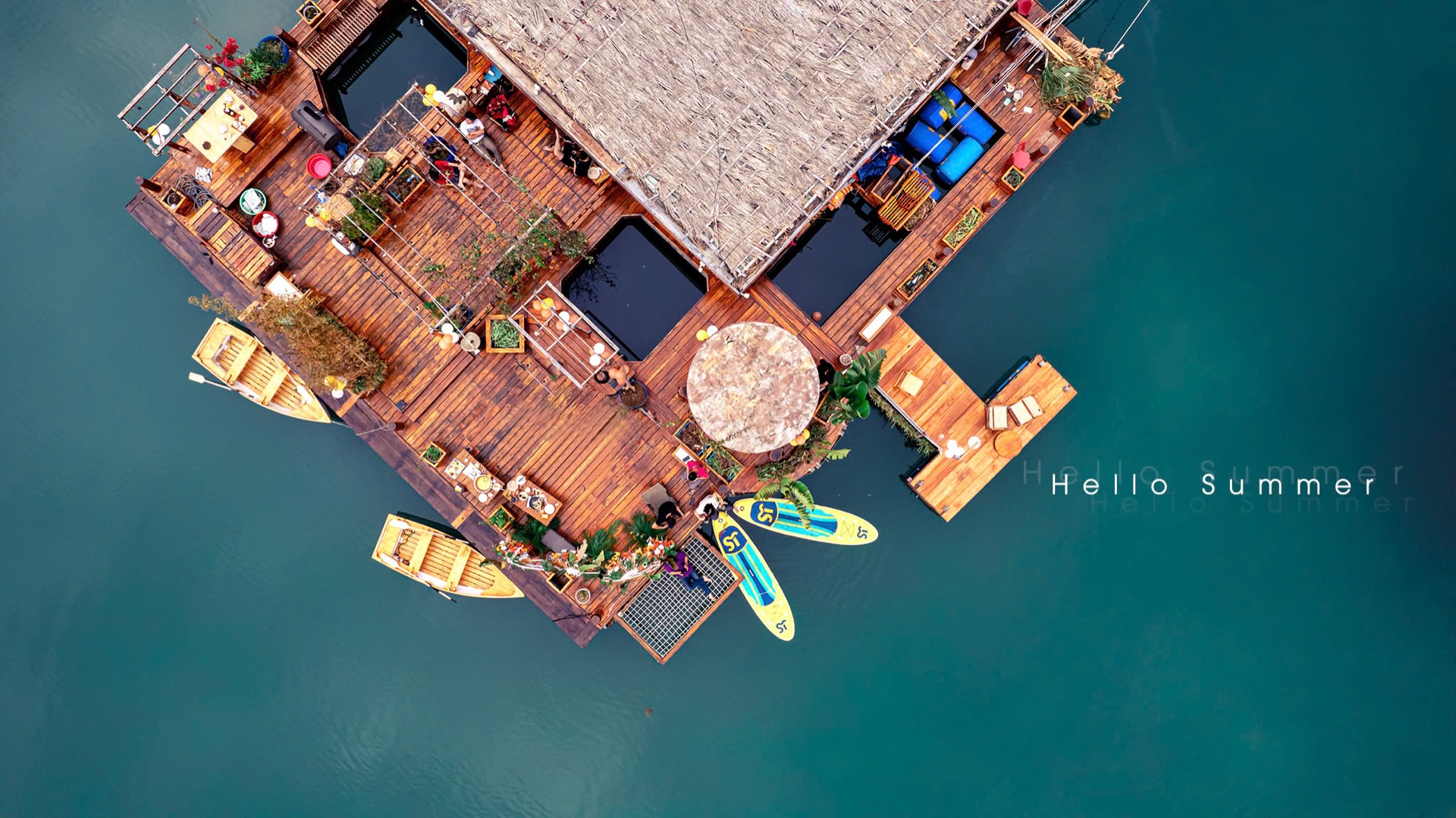 Drone view of the Lan Ha Floating Homestay deck with rowboats and paddleboards