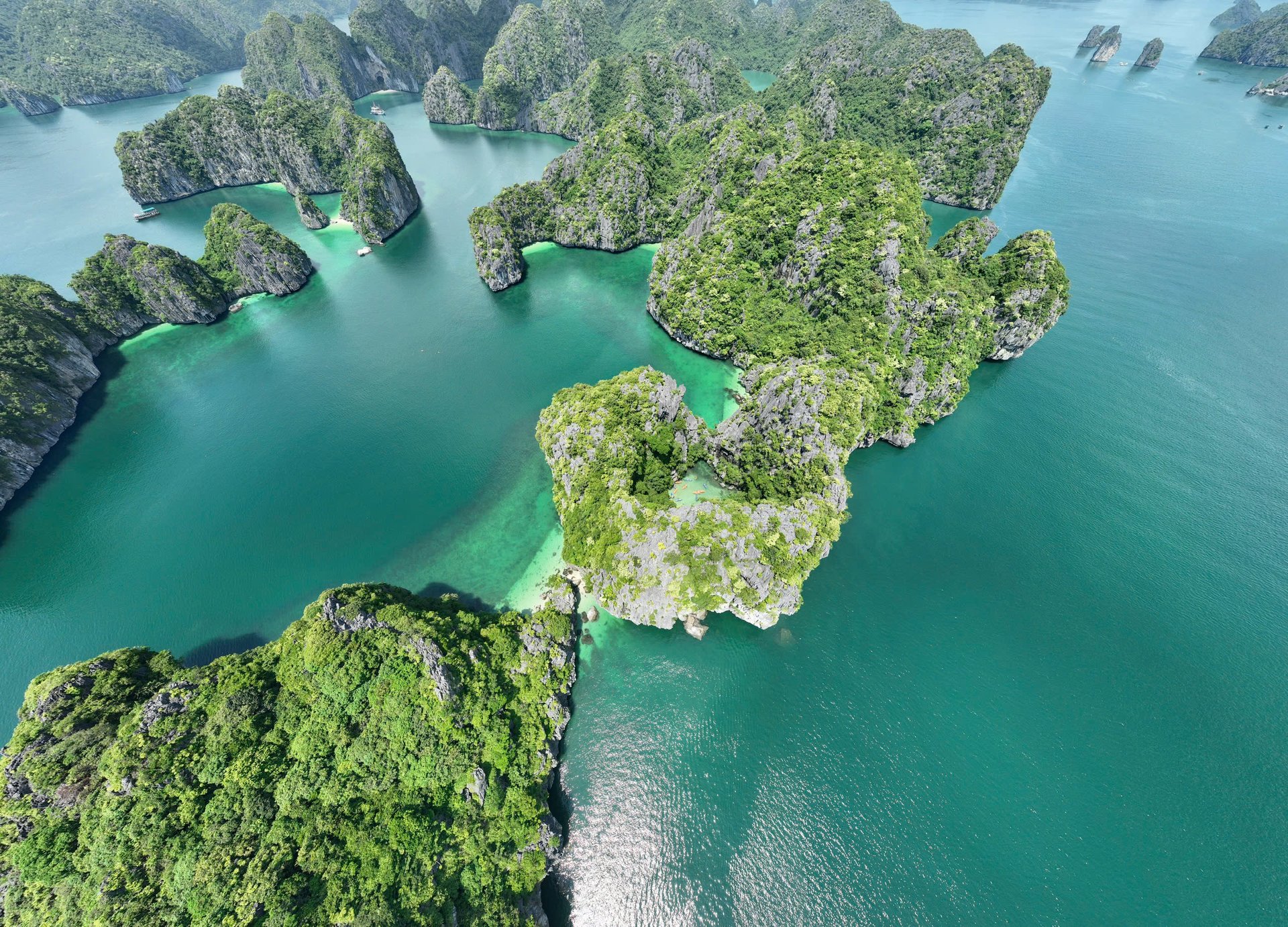 Aerial view of tidal sandbanks appearing between karst islets in Lan Ha Bay